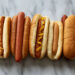 Ketchup on hot dog with hot dog rollers